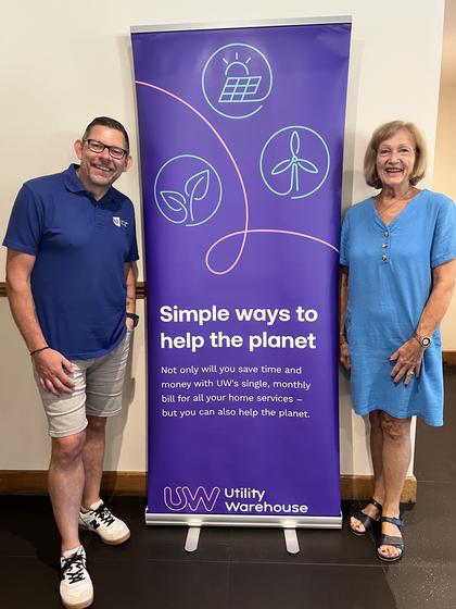 Two members either side of the Utility Warehouse banner