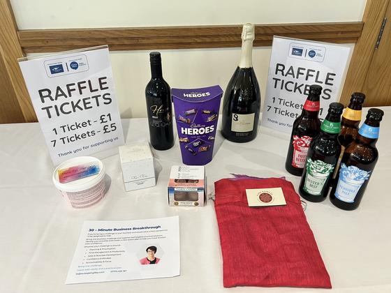 The charity raffle table with prizes and ticket prices