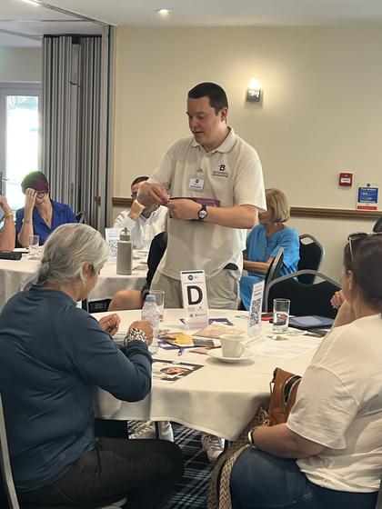 A member on his feet talking to his table