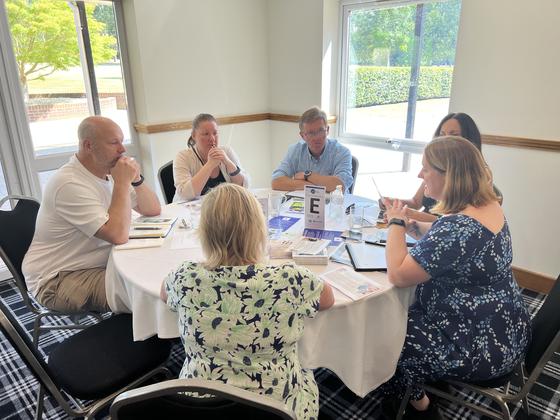 A busy table of members mid conversation