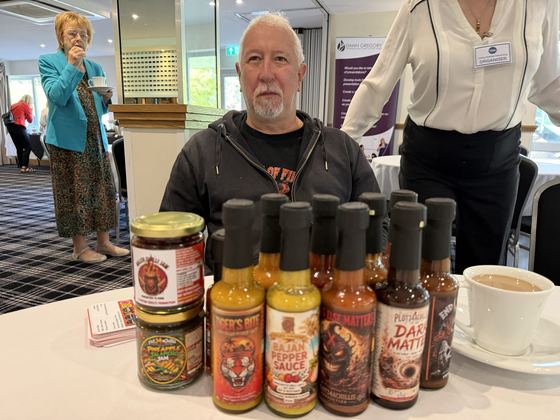 Bottles of hot sauce and jars of chutney on show at a member's table