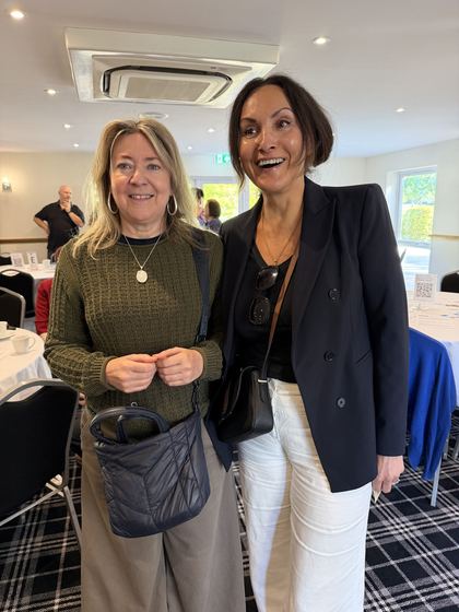 Two members sharing a smile in the meeting room