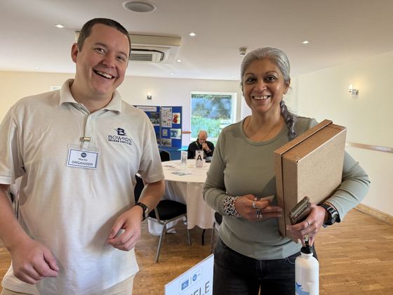 An organiser and a member sharing a laugh in the meeting room