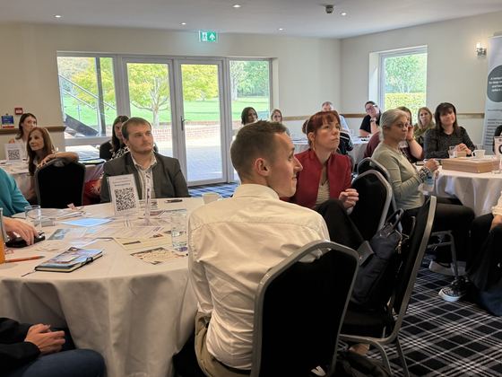 Members seated around the room during the talk
