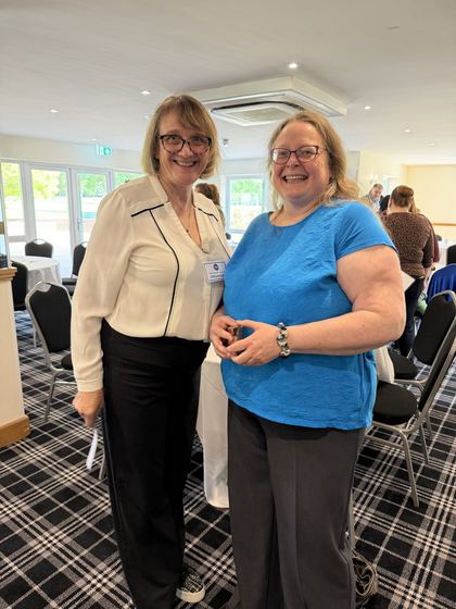 An organiser and a member smiling together