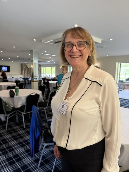 An organiser smiling in the meeting room after the talk